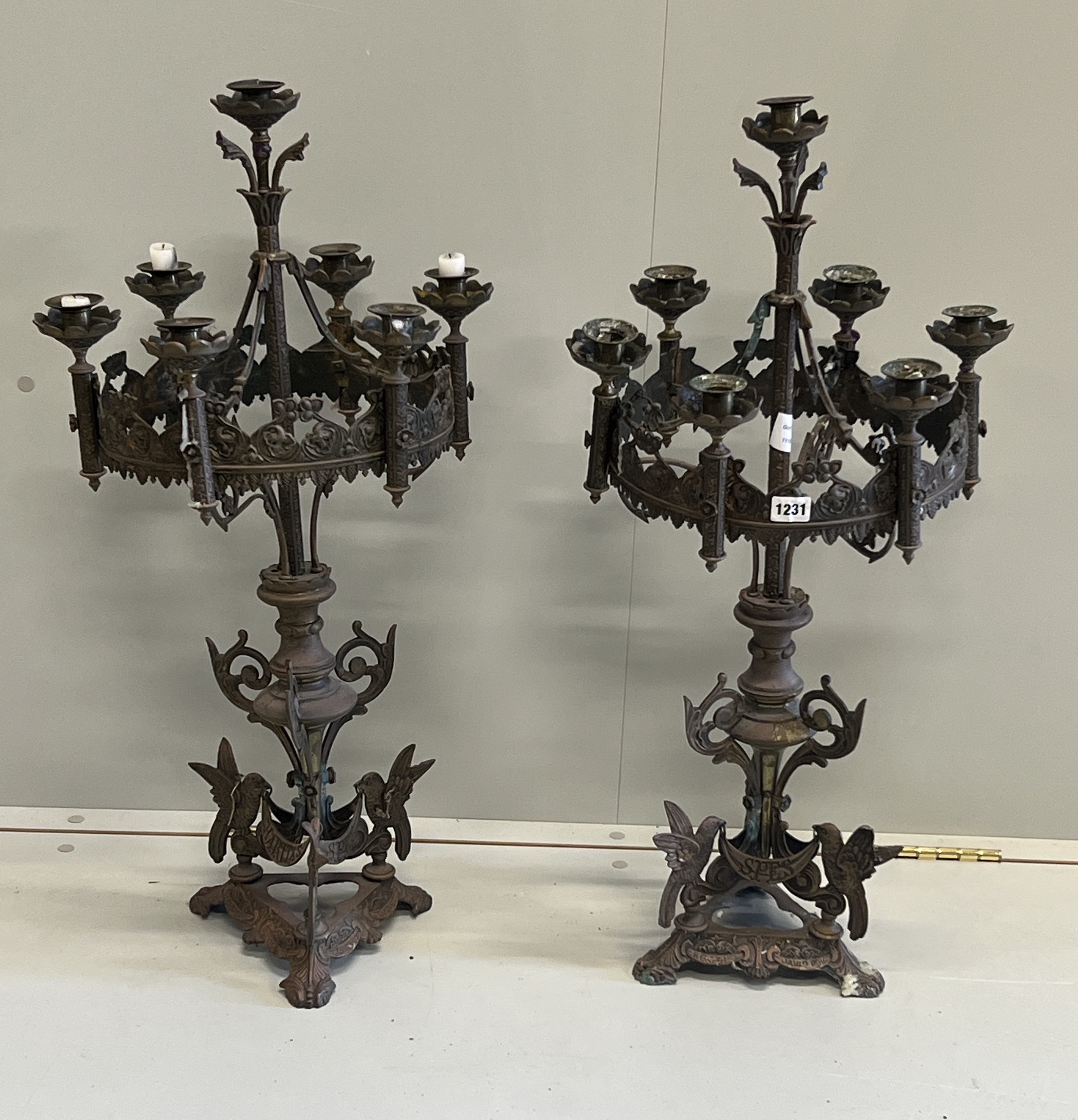 A pair of Gothic style seven branch cast metal candelabra, height 80cm